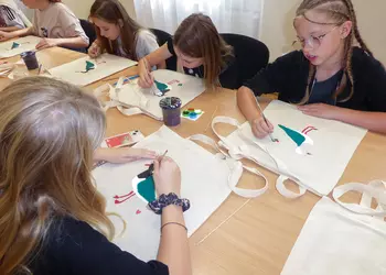 Dziewczęta malują czajki na swoich torbach