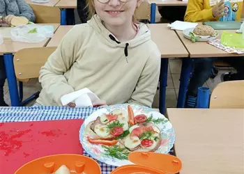 Uczennica klasy 3 prezentuje przygotowane kanapki