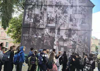 Przed muralem przedstawiającym historyczne wydarzenia miasta