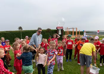 Najmłodsi biorą udział w zabawie z bańkami mydlanymi