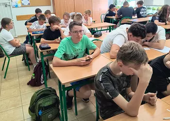 Uczniowie w grupach badają powietrze