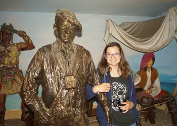 Uczennica przy figurze Arkadego Fiedlera